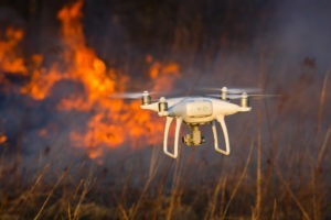 The drone flies against the background of a spring forest fire