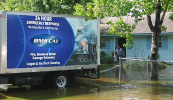 flood-disaster Water restoration company on-site at a single family home performing flood restoration.