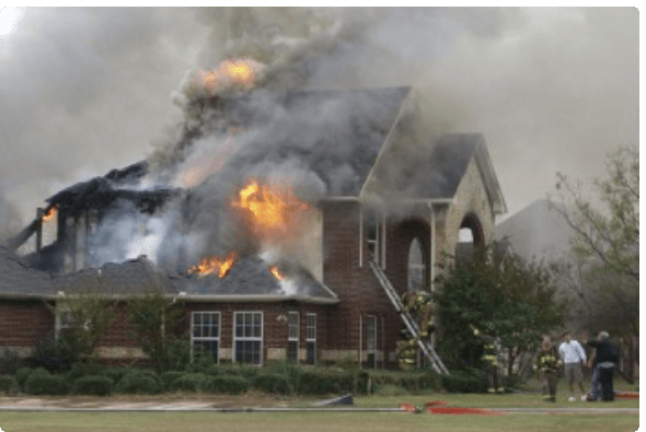 houseonfire Single family home that is on fire with firefighters in the yard attempting to extinguish the flames.