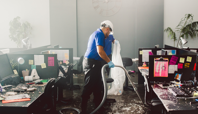 Water restoration company at a commercial office space performing water extraction.